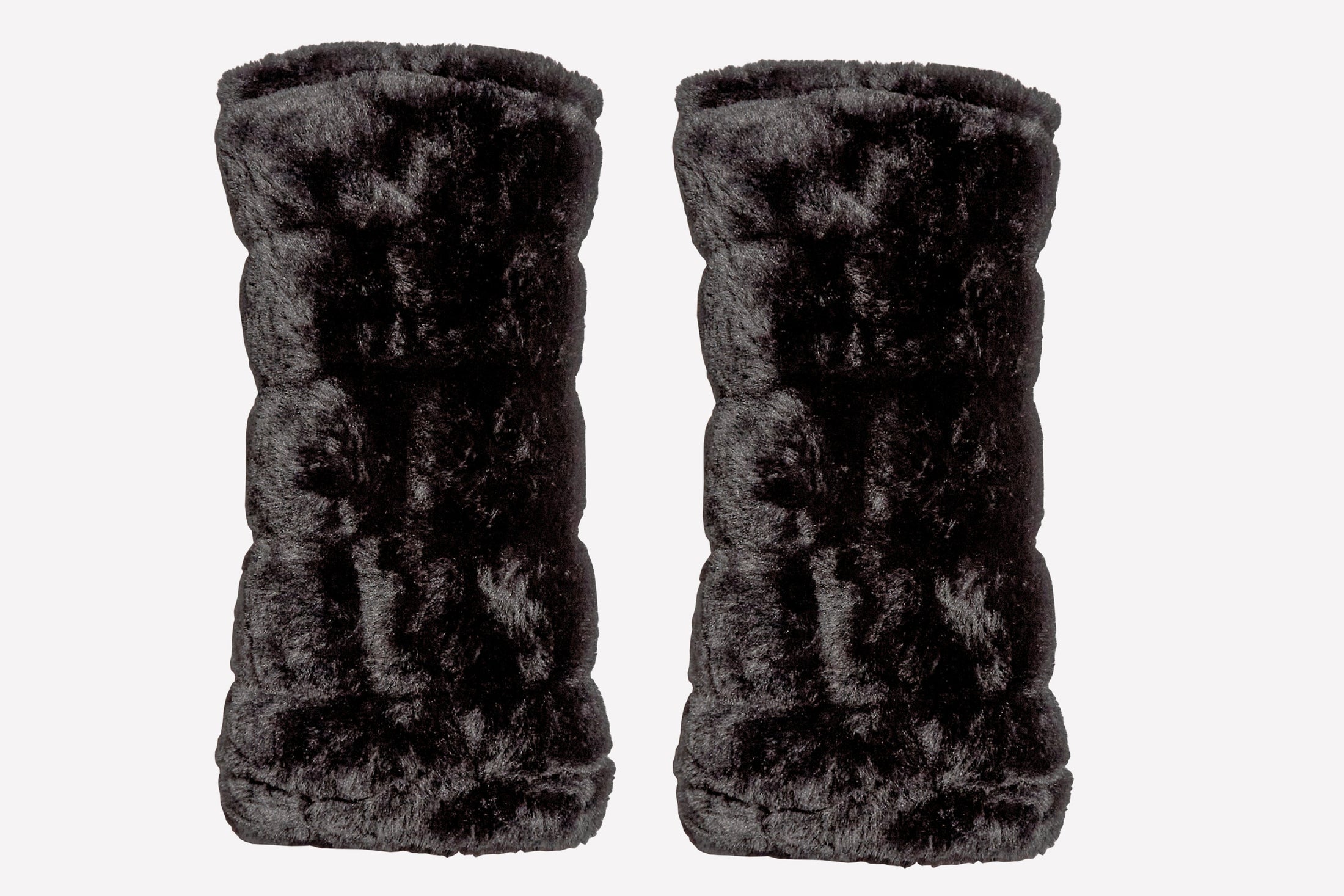Pair of black faux fur leg warmers on a white background